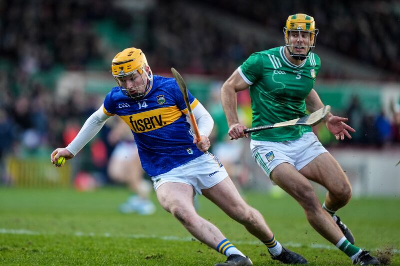 Sean Kenneally of Tipperary turns Dan Morrissey of Limerick. Photograph: James Lawlor/Inpho