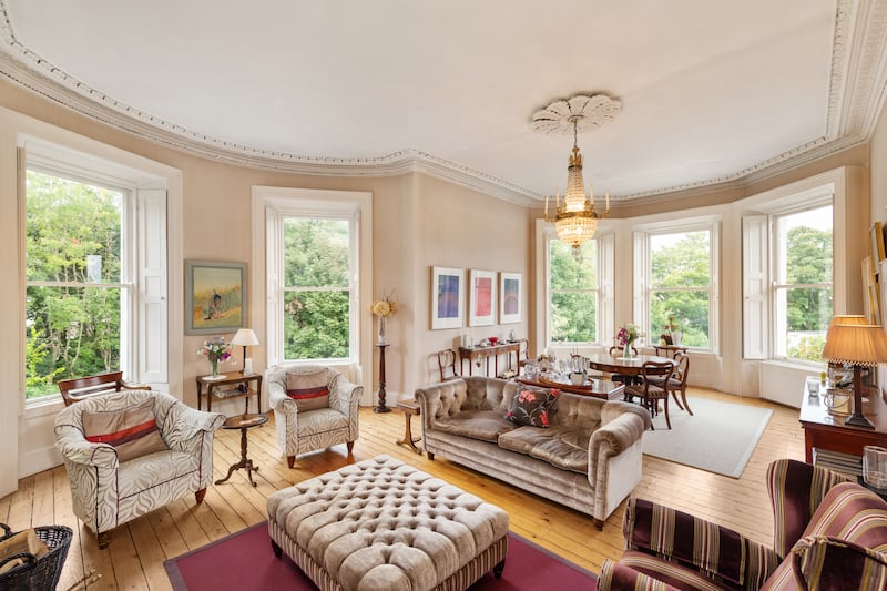 The main reception room has two sets of bay windows