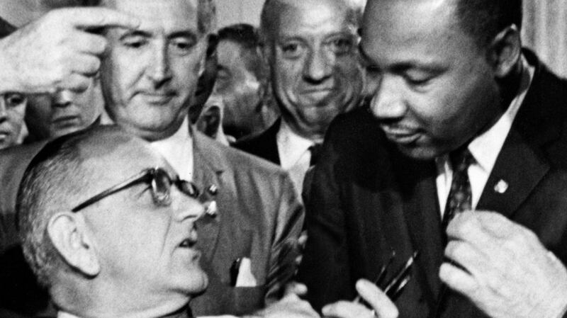 President Johnson greets the Rev Martin Luther King Jr at the signing of the 1964 Civil Rights Act