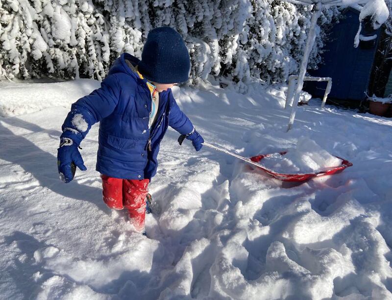 A child plays in the snow in a back garden in Belfast on Friday morning. Photograph: Lisa Payne 