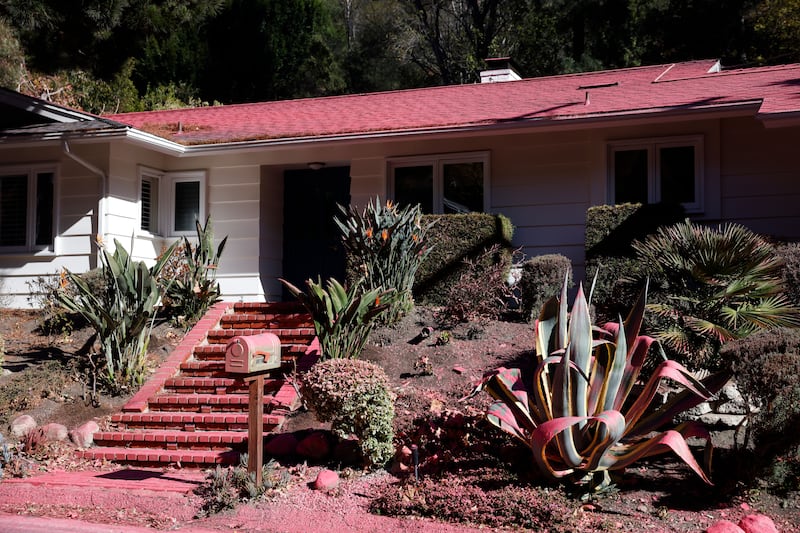 A house covered in fire retardant. Photograph: Caroline Brehman