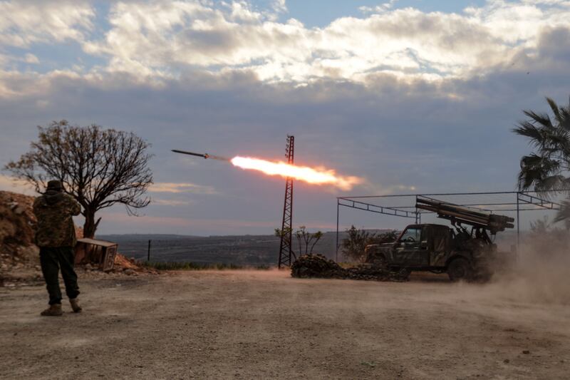 An anti-government fighter covers his ears as a multibarrel rocket launcher fires against regime forces, in the northern outskirts of Syria's west-central city of Hama on December 4th. Photograph: Bakr Al Kassem/AFP via Getty