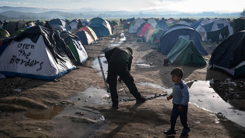 A man tries to drain the water at a makeshift camp after night’s rainfall near the Greek village of Idomeni at the Greek-Macedonian border. The European Commission has given EU member states until the end of the year to phase out all border checks introduced in the wake of the refugee crisis. Photograph: Louisa Gouliamaki/AFP/Getty Images.