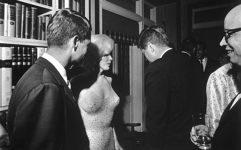 Then US president John F. Kennedy (with his back to the camera), his brother attorney general Robert Kennedy (far left), and actress Marilyn Monroe, on the occasion of President Kennedy's 45th birthday celebrations. Arthur M. Schlesinger is at the far right. Facing the camera in the rear is singer Harry Belafonte. Photograph: Cecil W. Stoughton / The White House