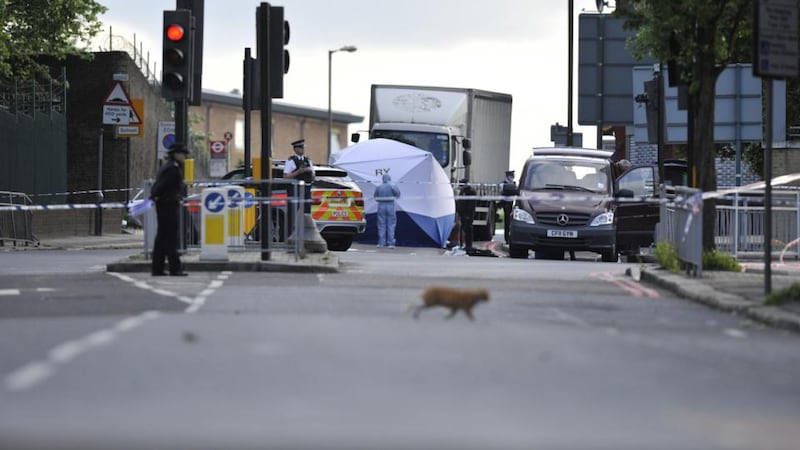 Police at the scene where a man was murdered in John Wilson Street, Woolwich, south London. Photograph:  Nick Ansell/PA Wire