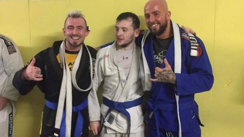 Aaron Burke (right) with his Brazilian jiu-jitsu sparring partners