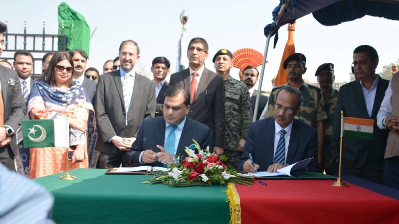 India’s SCL Das and Pakistan’s Mohammad Faisal sign an agreement on cross-border temple visits at “Zero Point” near Dera Baba Nanak in the border town of Gurdaspur, India. Photograph:  India’s Press Information Bureau