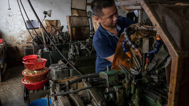 Hu Jiyan at his workshop, which has been plagued by power cuts, in Dongguan. Photograph: Gilles SabriŽ/The New York Times