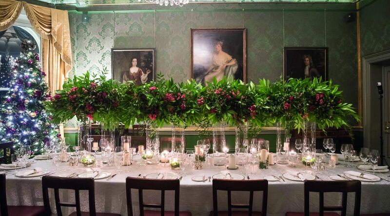 The Shelbourne’s head florist, Mary O’Reilly, suggests decorating your dining table with rows of tall clear vases, bursting with green foliage and a few red seasonal flowers