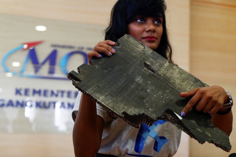 Grace Subathirai Nathan, daughter of MH370 passenger Anne Daisy, shows a serial number of debris found in Madagascar, believed to be from flight MH370, at a new conference in 2018. Photograph: Adli Ghazali/Anadolu Agency/Getty Images