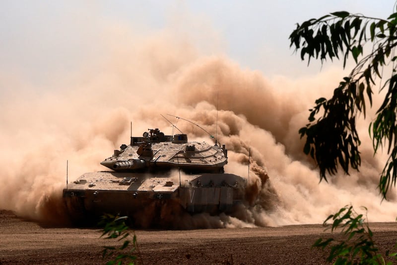 An Israeli army Merkava battle tank deploys with others along the border with the Gaza Strip in southern Israel. Photograph: Menahem Kahana/AFP via Getty Images