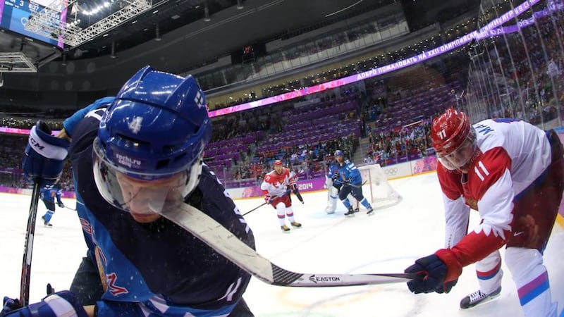 Yevgeni Malkin of Russia (right) hits Ossi Vaananen of Finland with his stick during the Men’s Ice Hockey quarter-final at the 2014 Sochi Winter Olympics at Bolshoi Ice Dome. Photograph:   Martin Rose/Getty Images