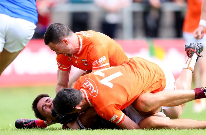 Galway's Sean Kelly is tackled by Rory Grugan and Aidan Forker of Armagh and Galway are awarded a penalty as a result at Avant Money Pairc Seán Mac Diarmuida, Carrick-on-Shannon. Photograph: Tom Maher/Inpho