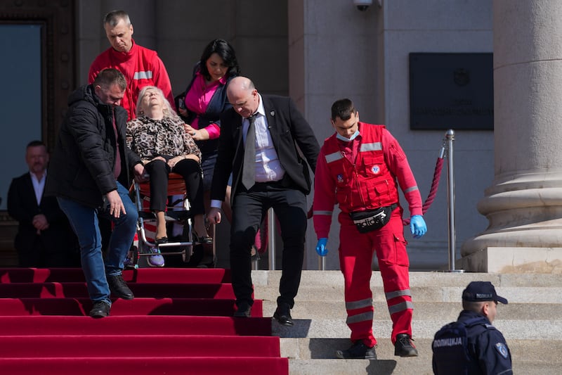 A politician was helped by medics following the incident (Darko Vojinovic/AP)