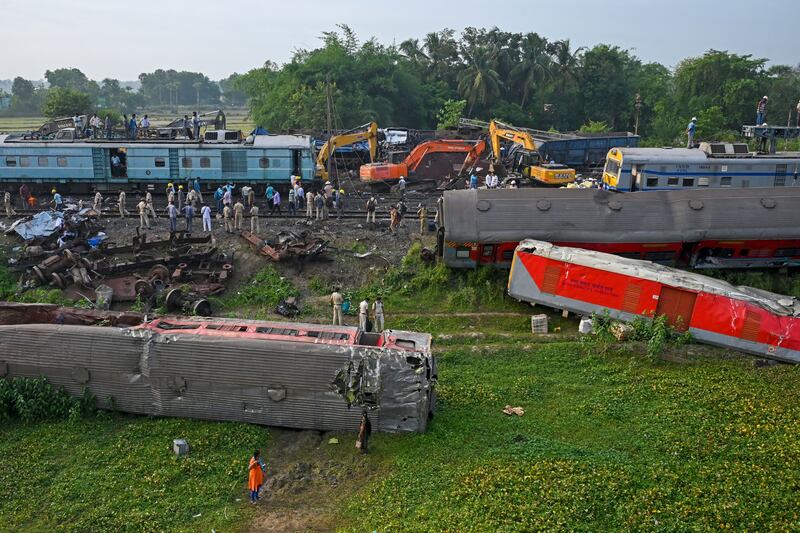 Police officers inspect the wrecked carriages of a three-train collision near Balasore, in India's eastern state of Odisha. Photograph: Dibyangshu Sarkar/AFP/Getty Images