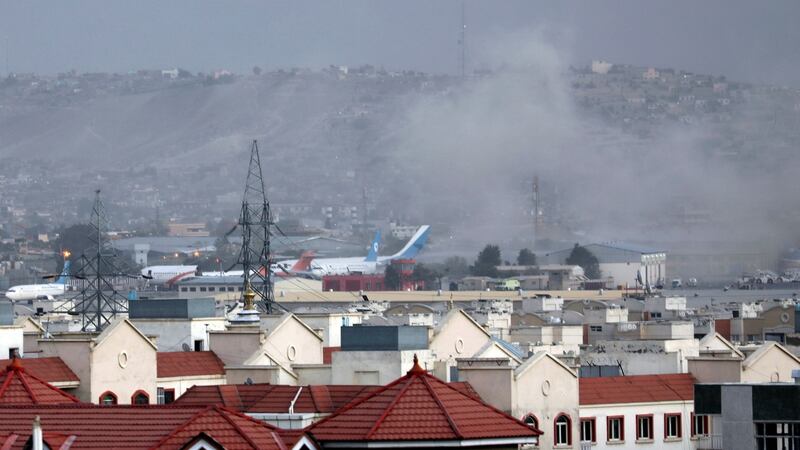 Smoke rises from an explosion outside the airport in Kabul, Afghanistan, on Thursday. Photograph: AP Photo/Wali Sabawoon