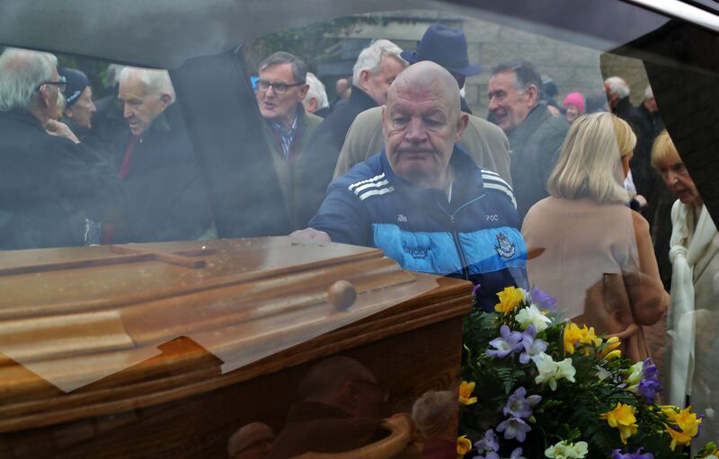 A Dublin fan touches Paddy Cullen's coffin after the funeral of the former Dublin goalkeeper and manager. Photograph: Colin Keegan/Collins