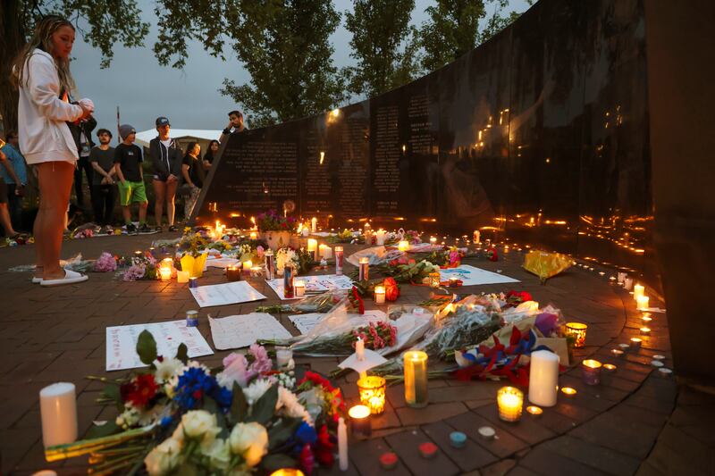 Dozens of mourners gather for a vigil near Central Avenue and St Johns Avenue in Highland Park: Audio recordings detail a series of single shots, a pause and then another burst of gunfire. Photograph: Anthony Vazquez/Chicago Sun-Times/AP