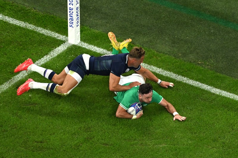 Hugo Keenan scores his team's second try whilst under pressure from Duhan van der Merwe of Scotland. Photograph: Matthias Hangst/Getty Images