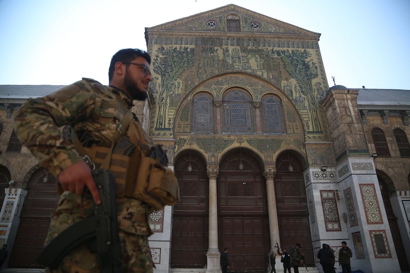 An armed rebel walks in the Umayyad Mosque in Damascus, Syria. Photograph: Bilal Alhammoud/EPA-EFE