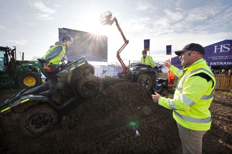 Noel Guinan from Compulsory Basic Training with Oran and Tighe Guinan demonstrating Health and Saftey around quad bikes and tractors at the Health and Safety Authority stand. Photograph: Alan Betson/The Irish Times