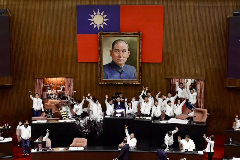 Taiwanese opposition lawmakers vote for a bill inside the Parliament building in Taipei, Taiwan, 20 December 2024. Thousands of protesters gathered outside Taipei's Legislative Yuan to voice their opposition to three contentious amendments, proposed by the opposition Kuomintang (KMT) party and Taiwan People's Party (TPP), that were up for vote, among them a revision to the Public Officials Election and Recall Act. Photograph: Richie B Tongo/EPA-EFE