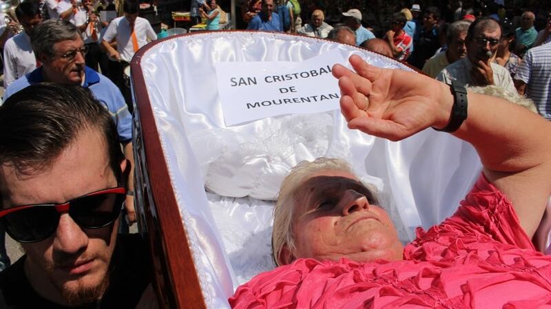 A ‘corpse’ shields her eyes from the sun at the Near Death festival in Las Nieves