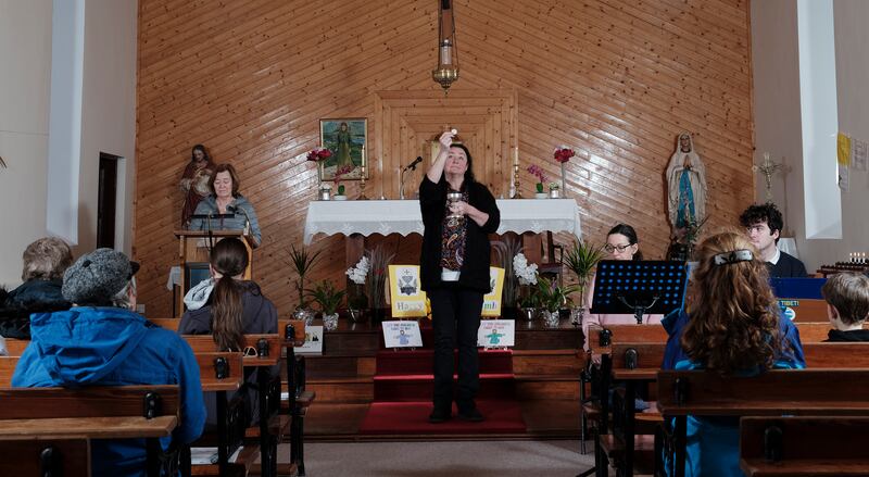 Lay parishioners on Clare Island practice carrying out a liturgical service, with eucharistic minister Sharon O'Grady holding up the consecrated eucharist. Photograph: Michael Mc Laughlin