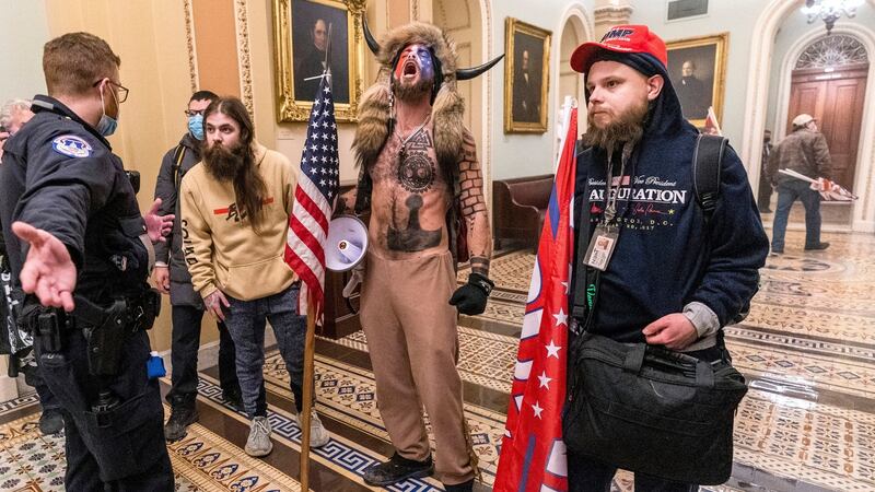 Supporters of US president Donald Trump are confronted by police officers outside the Senate chamber inside the Capitol after storming the building. Photograph: Manuel Balce Ceneta/AP Photo