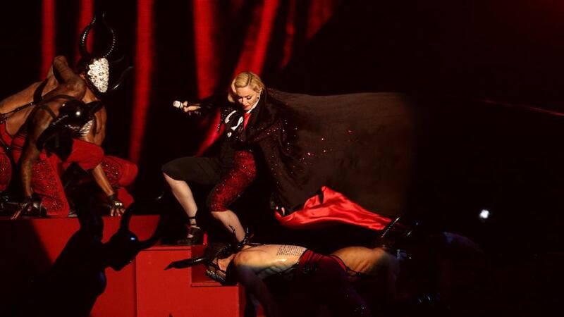 Madonna stumbles whilst performing on stage as her cape is pulled during the 2015 Brit Awards at the O2 Arena, London. Photograph: Yui Mok/PA Wire