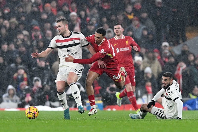 Manchester United's Matthijs de Ligt is challenged by Trent Alexander-Arnold, who endured a difficult day at Anfield on Sunday. Photograph: Liverpool FC/Liverpool FC via Getty Images