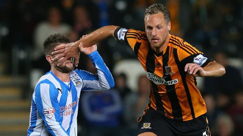 Hull City and Ireland midfielder David Meyler ‘hands off’ Oliver Norwood of Huddersfield Town  during their Capital One Cup third round match at the KC Stadium. Photograph: Julian Finney/Getty Images