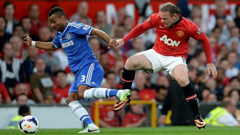 Chelsea’s Ashley Cole (left) and Manchester United’s Wayne Rooney battle for the ball at Old Trafford. Photograph: Martin Rickett/PA Wire