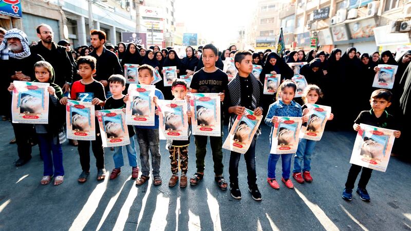 Iranian boys hold images of one of the victims Mohammad Taha Eghdami (4) during a public funeral ceremony for those killed during an attack on a military parade at the weekend, in the southwestern Iranian city of Ahvaz. Photograph: Atta Kenare/AFP/Getty Images