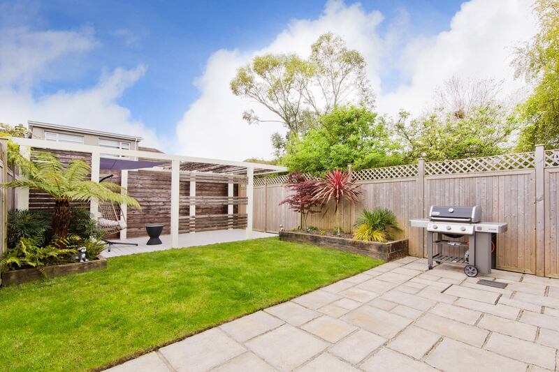 The property has a pergola in the rear garden