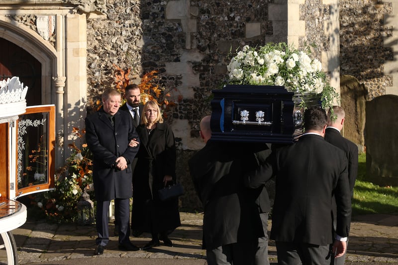 The parents of Liam Payne, Karen and Geoff Payne, watch as his coffin is carried into the funeral service. Photograph: Dan Kitwood/Getty Images