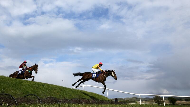 Barry Walsh riding Singing Banjo on their way to winning the Mongey Communications La Touche Cup Cross-Country Chase during day three of the Punchestown Festival. Photograph:  Brian Lawless/PA Wire