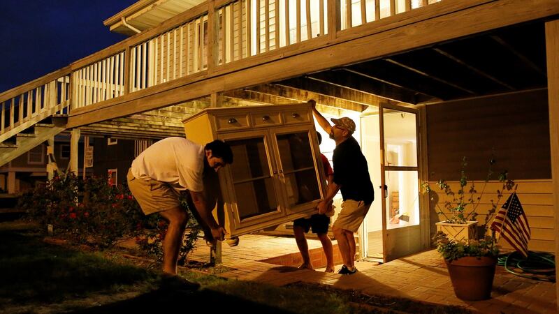 Reisdents remove furniture at a beachfront home along Waccamaw Drive in anticipation of Hurricane Matthew in Garden City Beach, South Carolina, US. Photograph: Randall Hill/Reuters