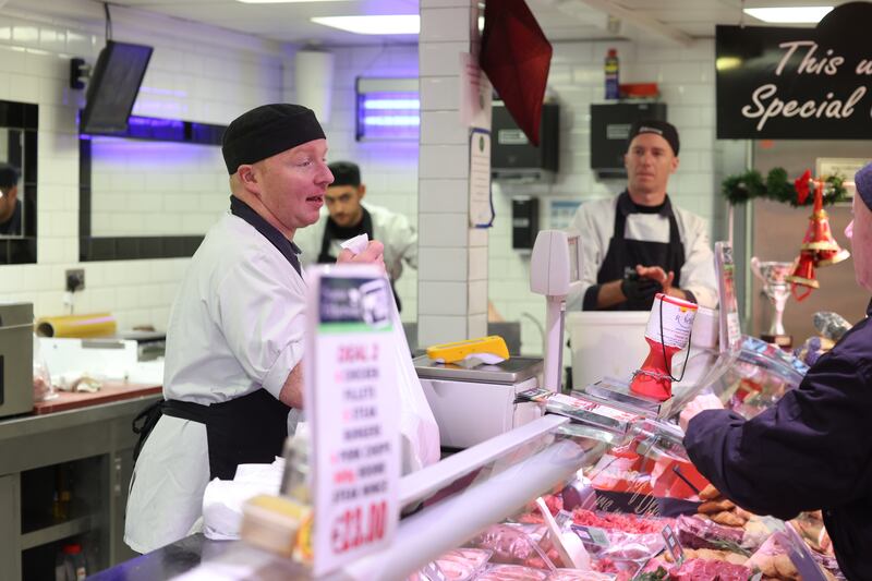 Paul Lambe (left) at work in Etherson’s butchers' shop in Cabra, Dublin, a family-run business owned by Seamus Etherson. Photograph: Bryan O’Brien/The Irish Times


