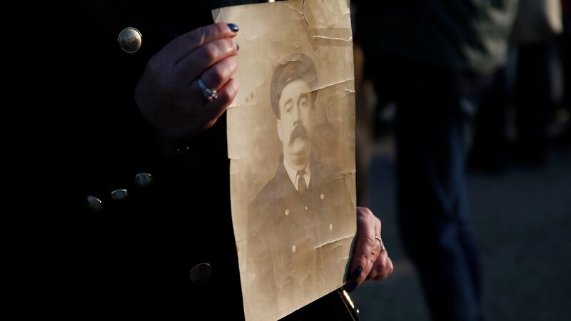 A relative holds a photograph of Seaman John Donohoe who survived the sinking. Photograph: Nick Bradshaw/The Irish Times