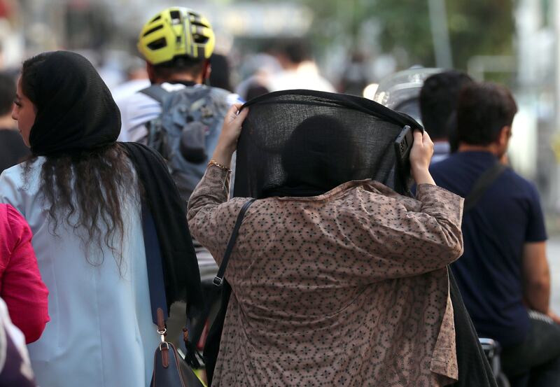 An Iranian woman adjusts her headscarf or hijab in Tehran, Iran, in August. Iran's President Ebrahim Raisi has vowed that the Islamic Republic's mandatory dress code, including laws requiring women to wear the hijab, will be enforced. Photograph: Abedin Taherkenareh/EPA