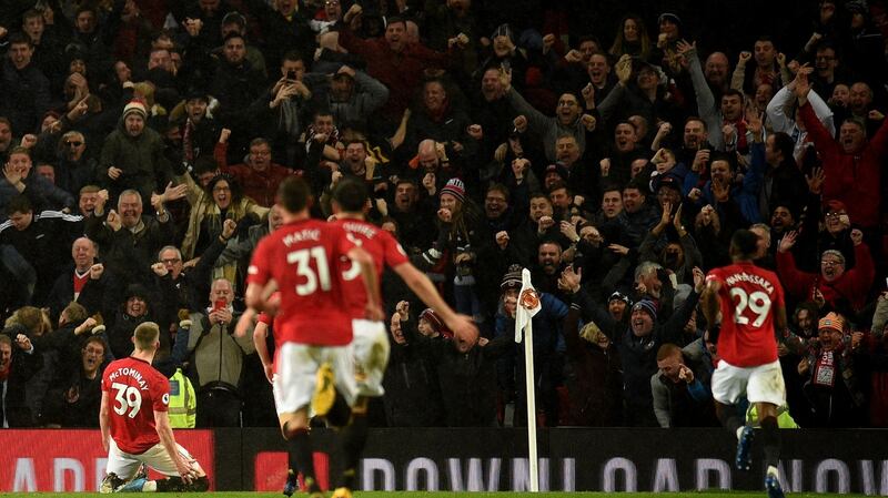 The Stretford End celebrates after Scott McTominay’s goal in the last Manchester derby. Photo: Oli Scarff/AFP via Getty Images