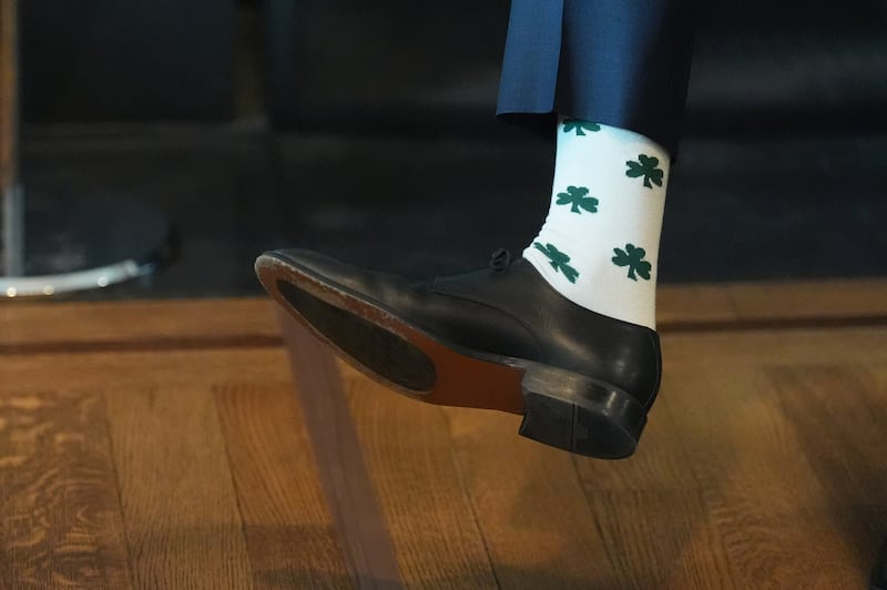 US vice-president JD Vance showing off his Shamrock socks while speaking at the breakfast meeting  nwith Taoiseach