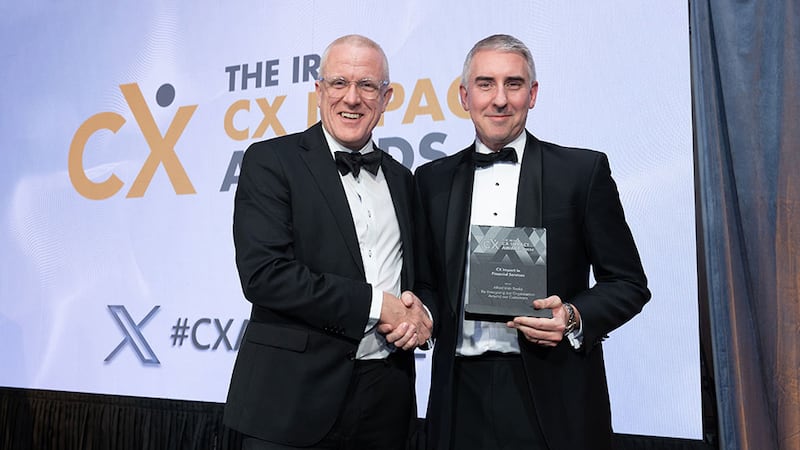 Tim Farmer, awards judge, presents the CX impact in financial services award to Paul Allen, Allied Irish Banks