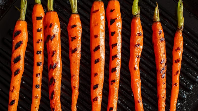 The carrots are prepared on a grill pan, leaving contrasting sear marks.