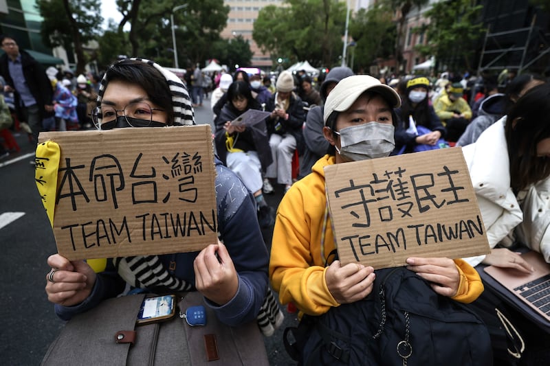 Demonstrators display placards during a protest against three bills proposed by Taiwan's opposition parties, outside the Parliament building in Taipei, Taiwan. Photograph: Richie B Tongo/EPA-EFE