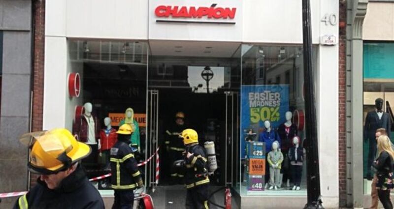 Dublin Fire Brigade personel outside the Champion Sports store. Photograph: Killian O'Sullivan