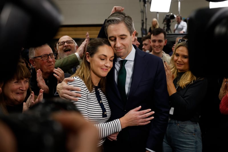 An Taoiseach Simon Harris TD with his wife Caoimhe as he was elected on the first count in the Greystones count centre. Photograph: Nick Bradshaw / The Irish Times