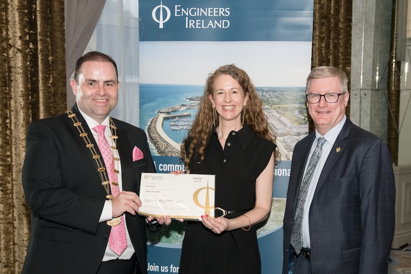 Orla Burke is awarded the title of Fellow by EI president Edmond Harty, with Damien Owens, director general of EI, at the Cork region event