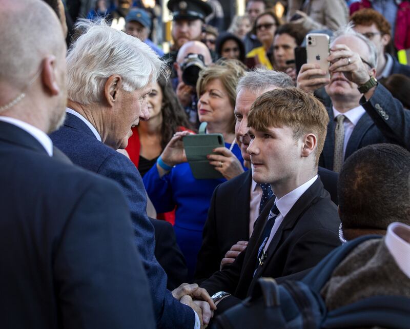 Former US president Bill Clinton speaks with St Columb's College student James Tourish at the Guildhall in Derry. Photograph: Liam McBurney/PA